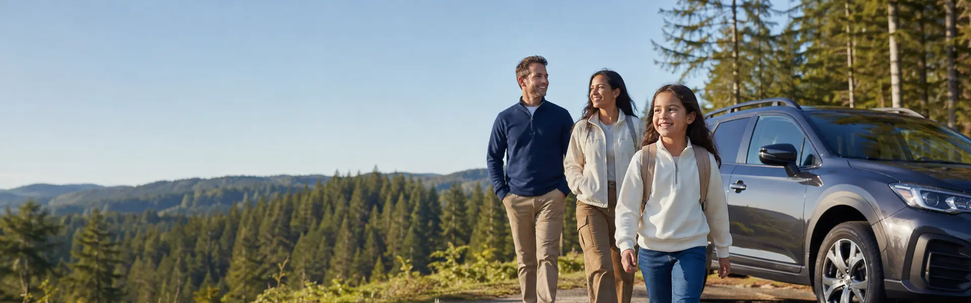 Happy family next to their car